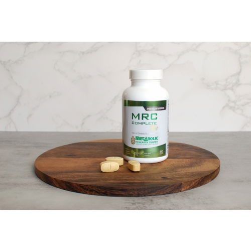 MRC Complete Plus Multivitamin Tablets for Men bottle on a wooden board with 3 tablets arranged in front