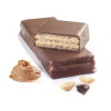 beauty shot of peanut chocolate protein wafer bars showing the crispy wafer interior with peanuts, a peanut butter dollop, and chunk of chocolate on the side