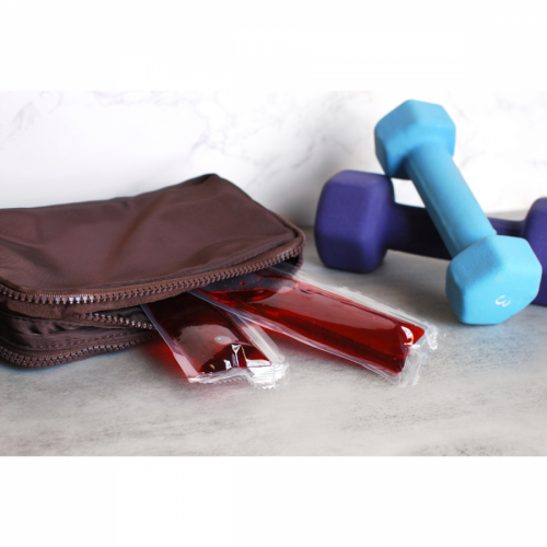 Metabolic Web Store MRC Mixed Berry protein drink packets in a gym bag next to some hand weights