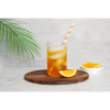 MRC's orange protein drink concentrate mixed in a clear glass with water. The glass in on a circular bamboo board with a fresh orange slice next to the glass an in a small bowl set behind the board.