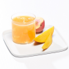 Metabolic Web Store MRC Peach Mango protein drink in a glass with sliced peaches and mango